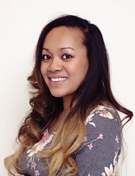 Headshot of a woman smiling in a professional portrait